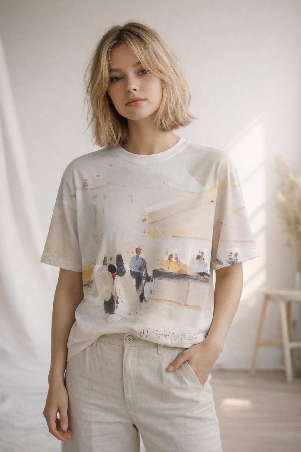 Person wearing a graphic t-shirt with a design of people in a cityscape.