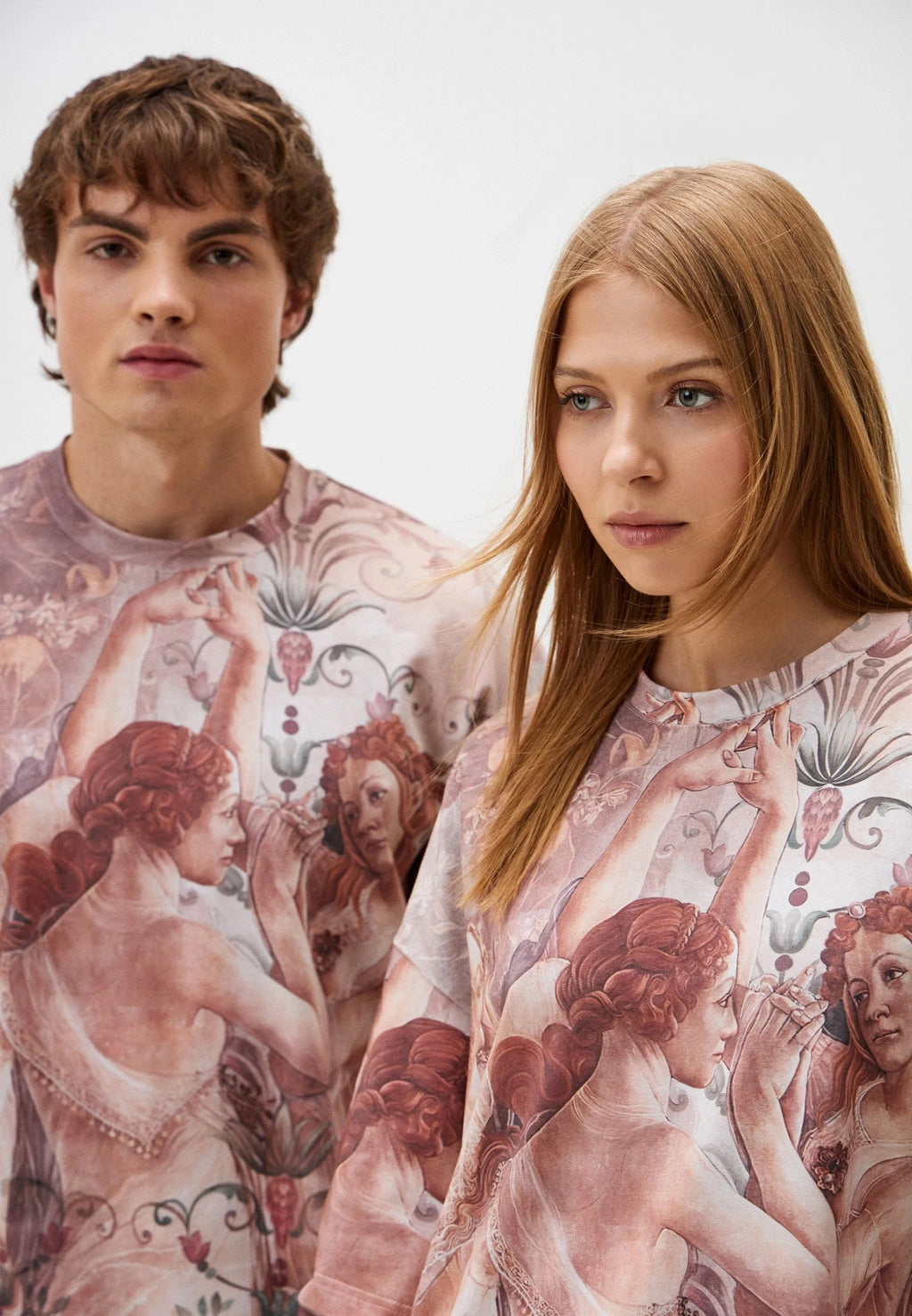 Two people wearing matching t-shirts with printed paintings design