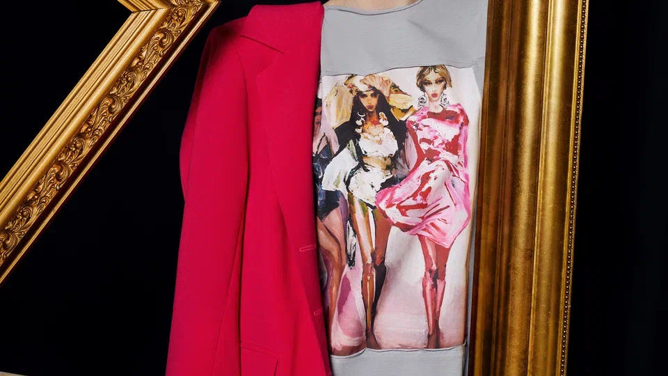 Person wearing a red outfit with a gold frame and a magazine featuring fashion models.