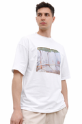 Man wearing a white t-shirt with a graphic design with trees on a white background
