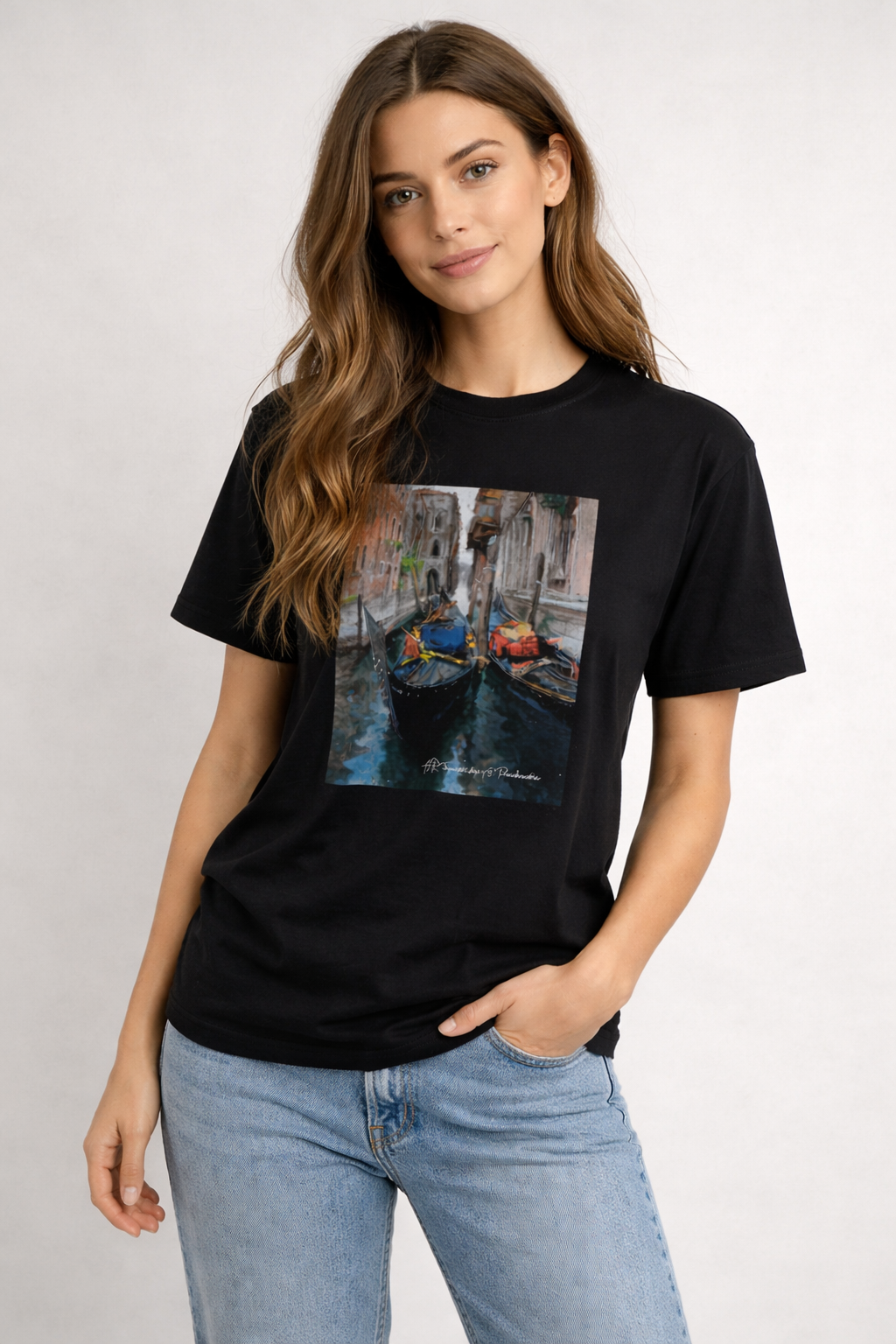Woman wearing a black t-shirt with a graphic of a canal scene.